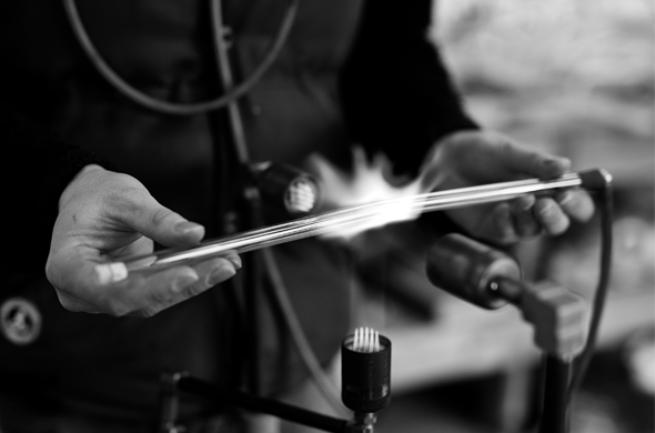 Kevin Killen at work, bending glass over a flame